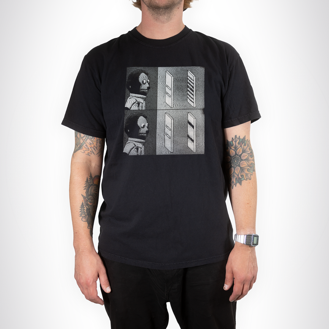 Model wearing the black Double Slit Shirt with a grayscale quantum experiment graphic