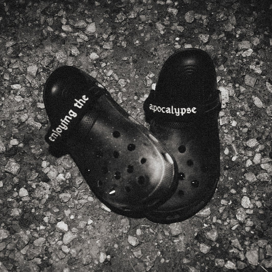 NIHILOCKS customized black Crocs with gunmetal spikes and embroidered wraps