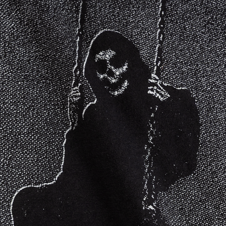 Close-up of the grim figure on a swing print