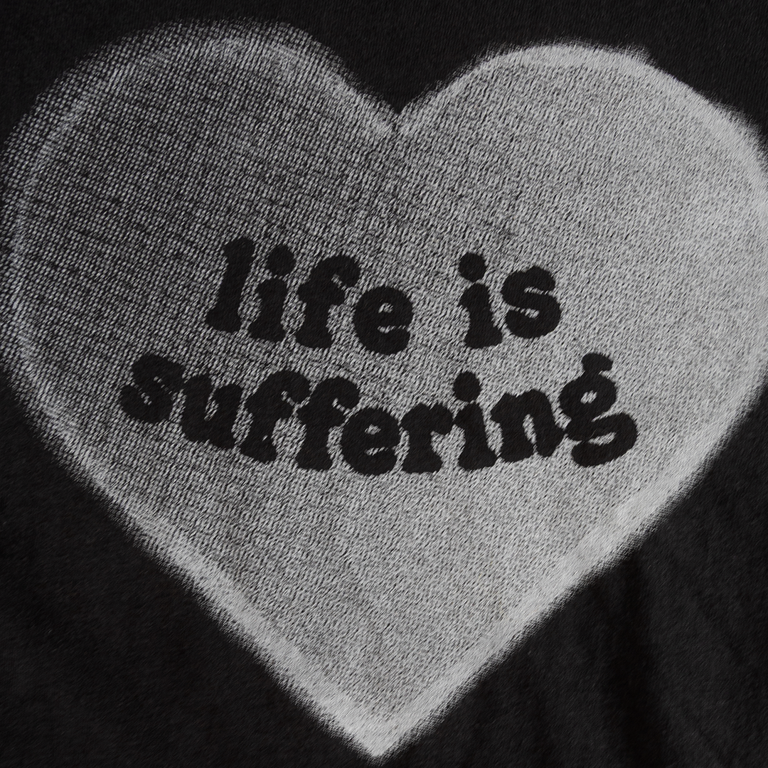 Close-up of Life Is Suffering heart graphic