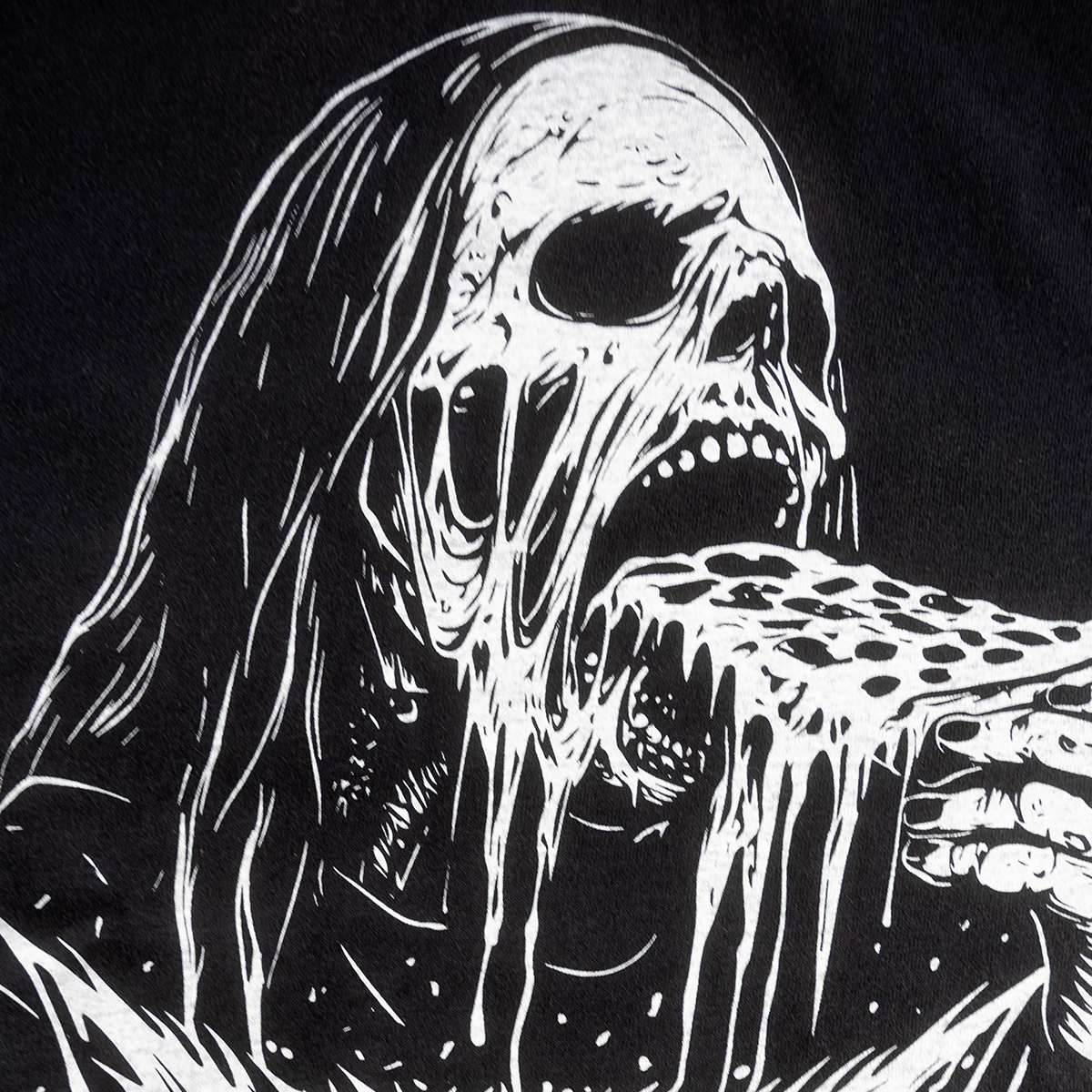 Close-up of the skeleton and pizza graphic on the Pizzza Party shirt