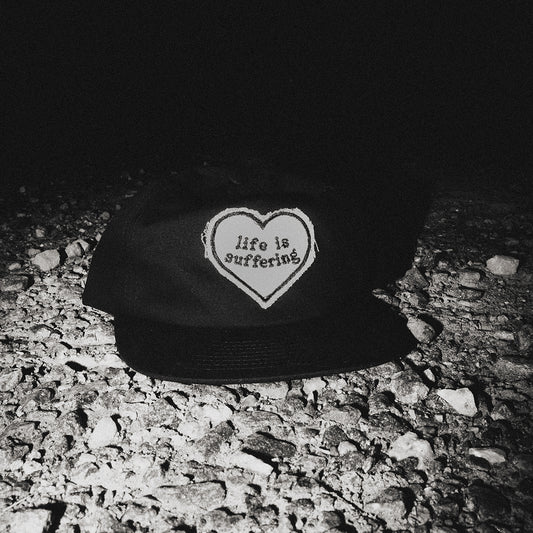 Suffering Hat front view with Life Is Suffering heart patch